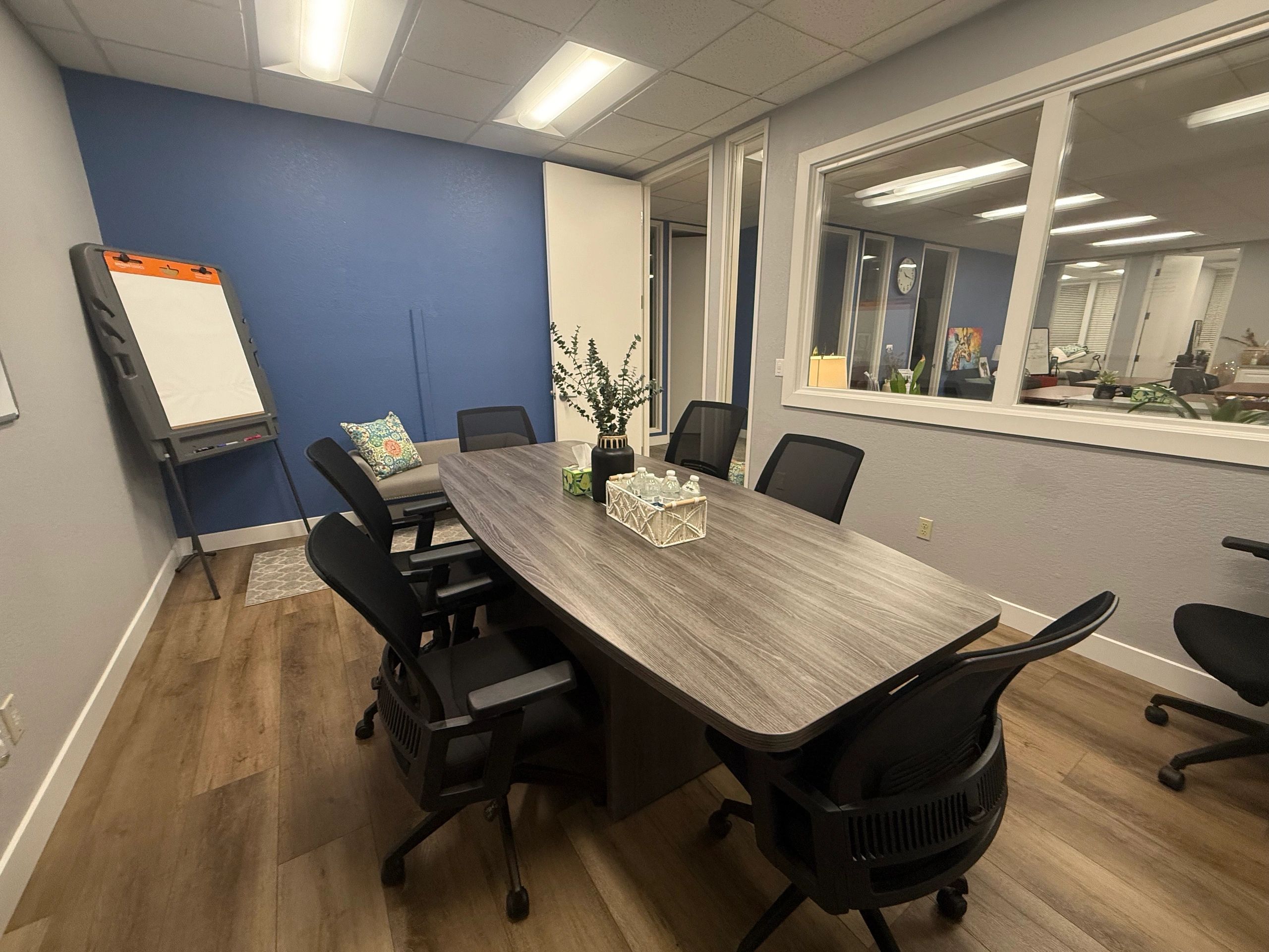 Sacramento conference room with boardroom table and blue accent wall — Consulting, E.T.C.
